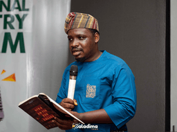 "Adetimilehin ‘Vic’Adex’ Inioluwa Victor reading poetry at the National Poetry Slam, highlighting his emotional and cultural voice."
